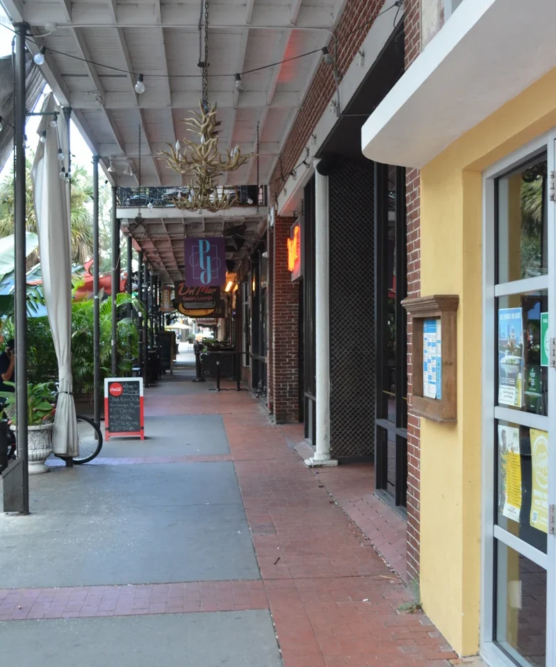 A covered sidewalk and storefronts on Central Avenue between 2nd and 3rd